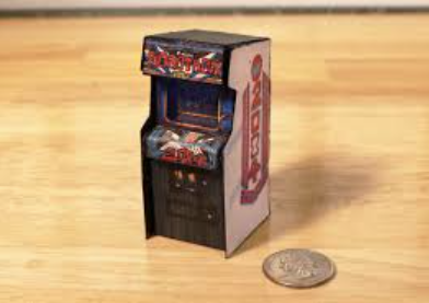 A 1/6 scale Robotron 2084 cabinet next to a quarter for scale